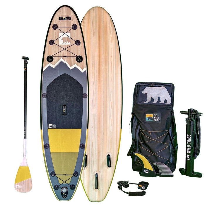 The Wild Tribe Peyto 11 inflatable paddle board kit with wood-grain deck, yellow accents and accessories